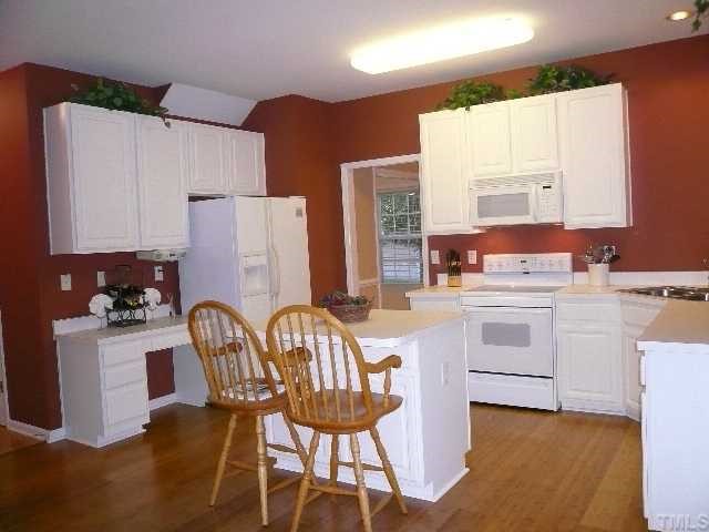 8008 Strawberry Meadows Street Raleigh, NC 27613 - Photo 5 of 12 The kitchen also features new Bamboo laminate wood floors, a planning desk area, raised panel cabinets, a side by side refrigerator and a large pantry!