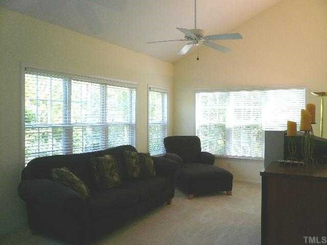8008 Strawberry Meadows Street Raleigh, NC 27613 - Photo 6 of 12 The sun room/family room is right off the kitchen with vaulted ceiling, fresh paint, ceiling fan, custom blinds and tons of windows for natural light.