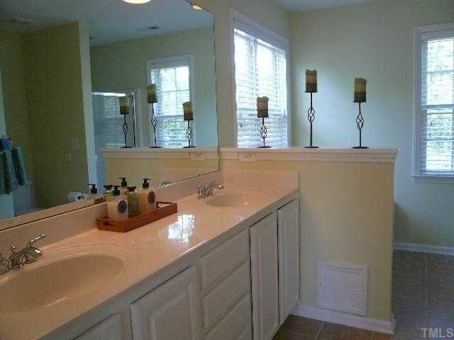 8008 Strawberry Meadows Street Raleigh, NC 27613 - Photo 8 of 12 The master bath is fabulous with new porcelain tile floors, dual vanity sink with cultured marble top, fresh paint, new light fixtures and a large walk in closet.