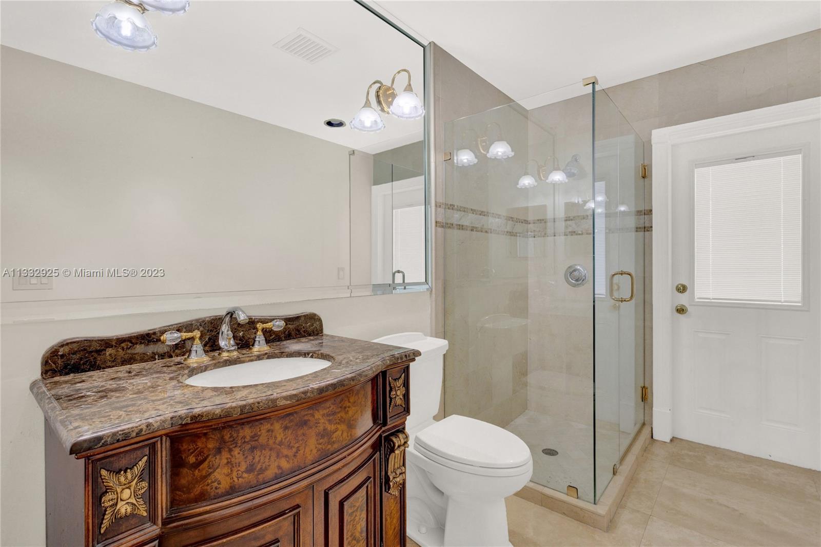 19610 Dinner Key Drive Boca Raton, FL 33498 - Photo 13 of 27 a bathroom with a granite countertop sink a toilet a mirror and shower