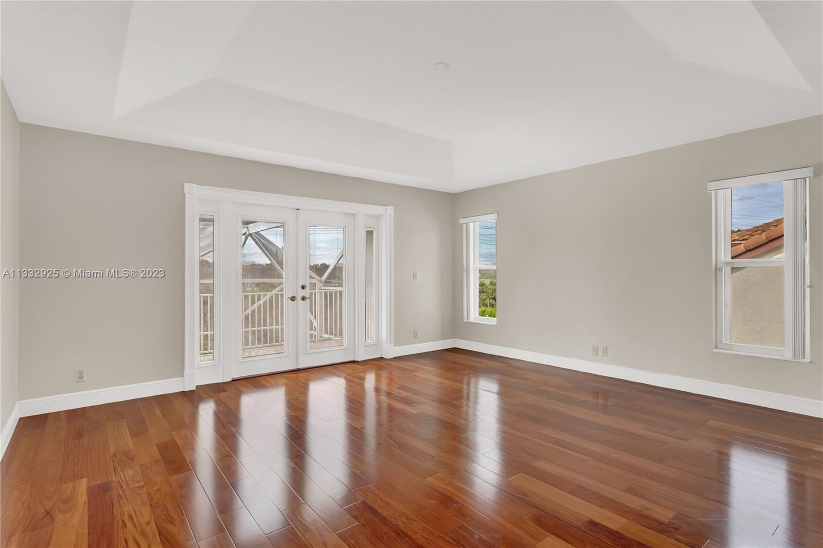 19610 Dinner Key Drive Boca Raton, FL 33498 - Photo 16 of 27 a view of an empty room with wooden floor and a window