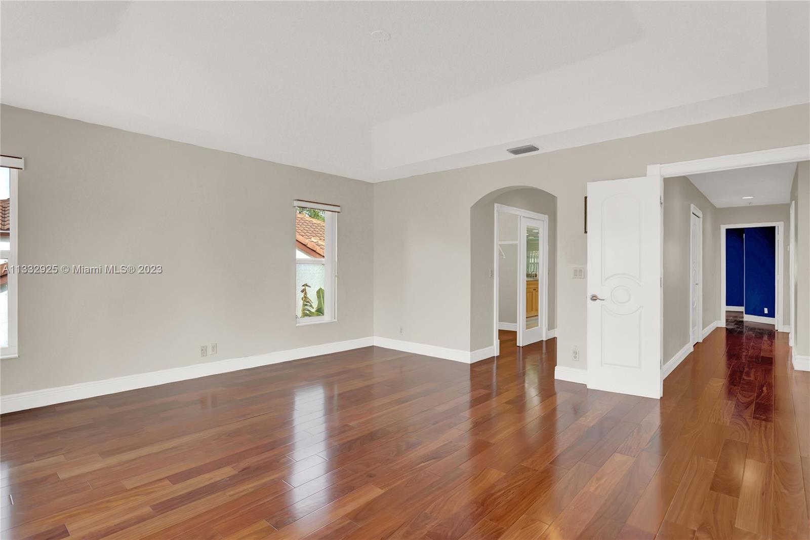 19610 Dinner Key Drive Boca Raton, FL 33498 - Photo 17 of 27 an empty room with wooden floor and windows