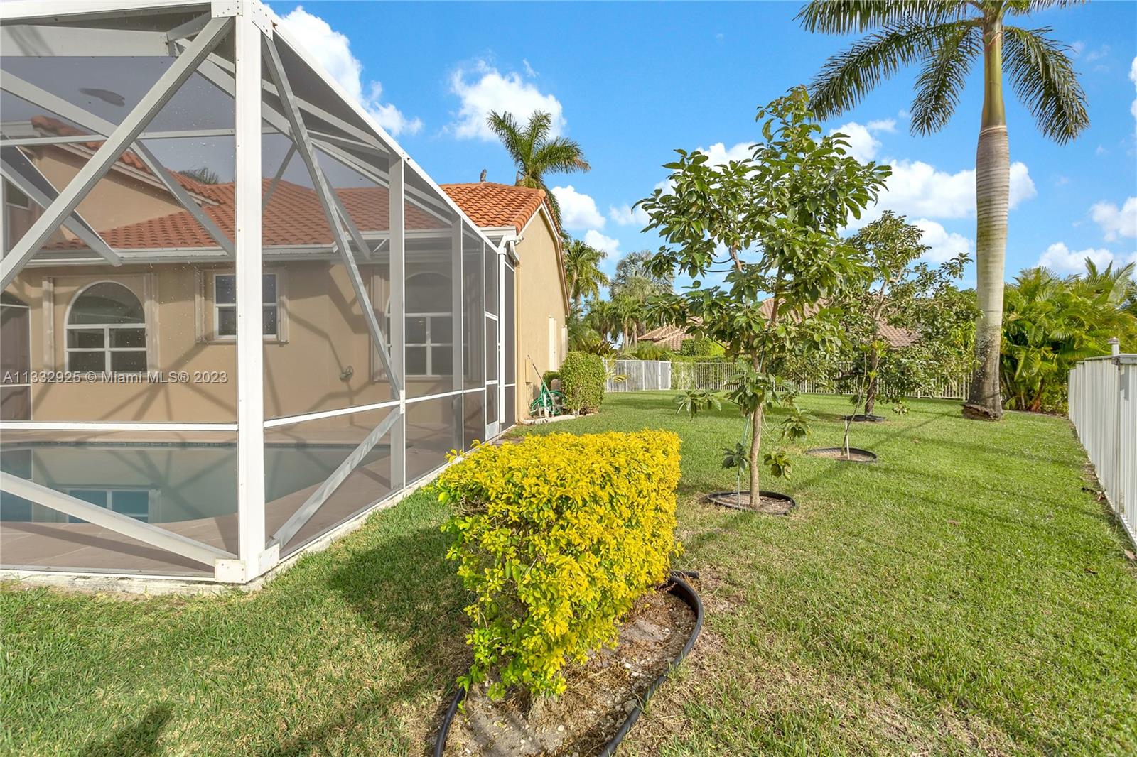 19610 Dinner Key Drive Boca Raton, FL 33498 - Photo 26 of 27 a view of an house with backyard and a tree