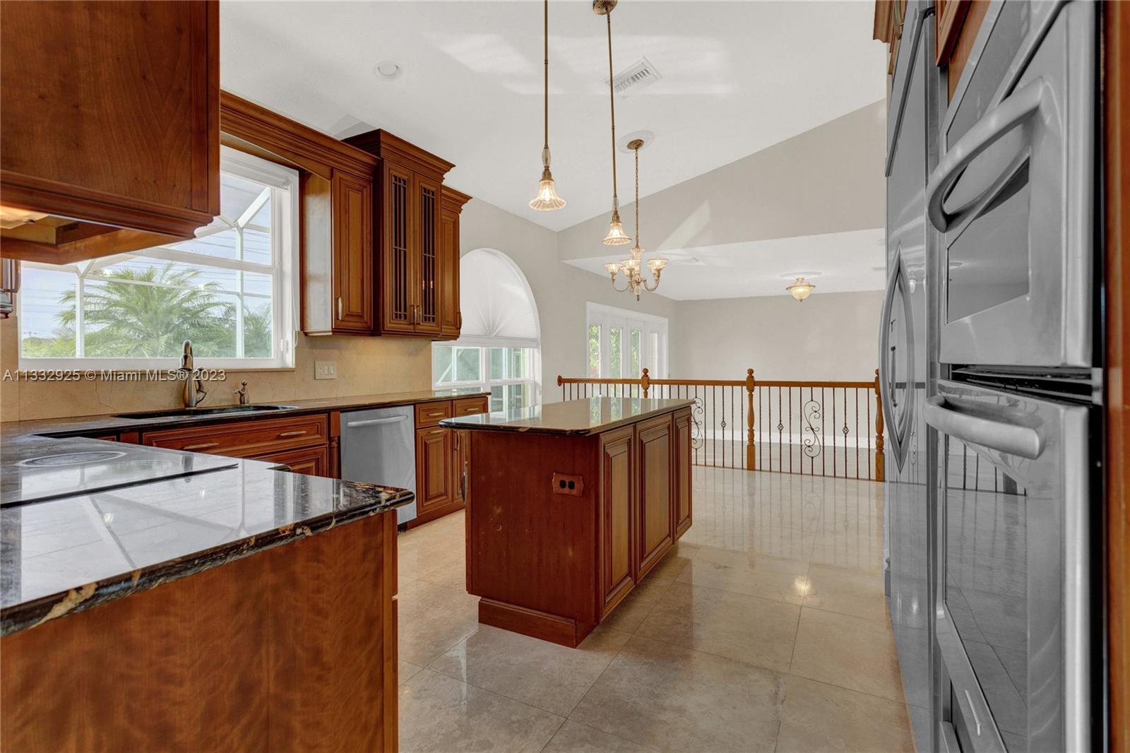 19610 Dinner Key Drive Boca Raton, FL 33498 - Photo 9 of 27 a kitchen with stainless steel appliances granite countertop a sink a stove and a wooden floors