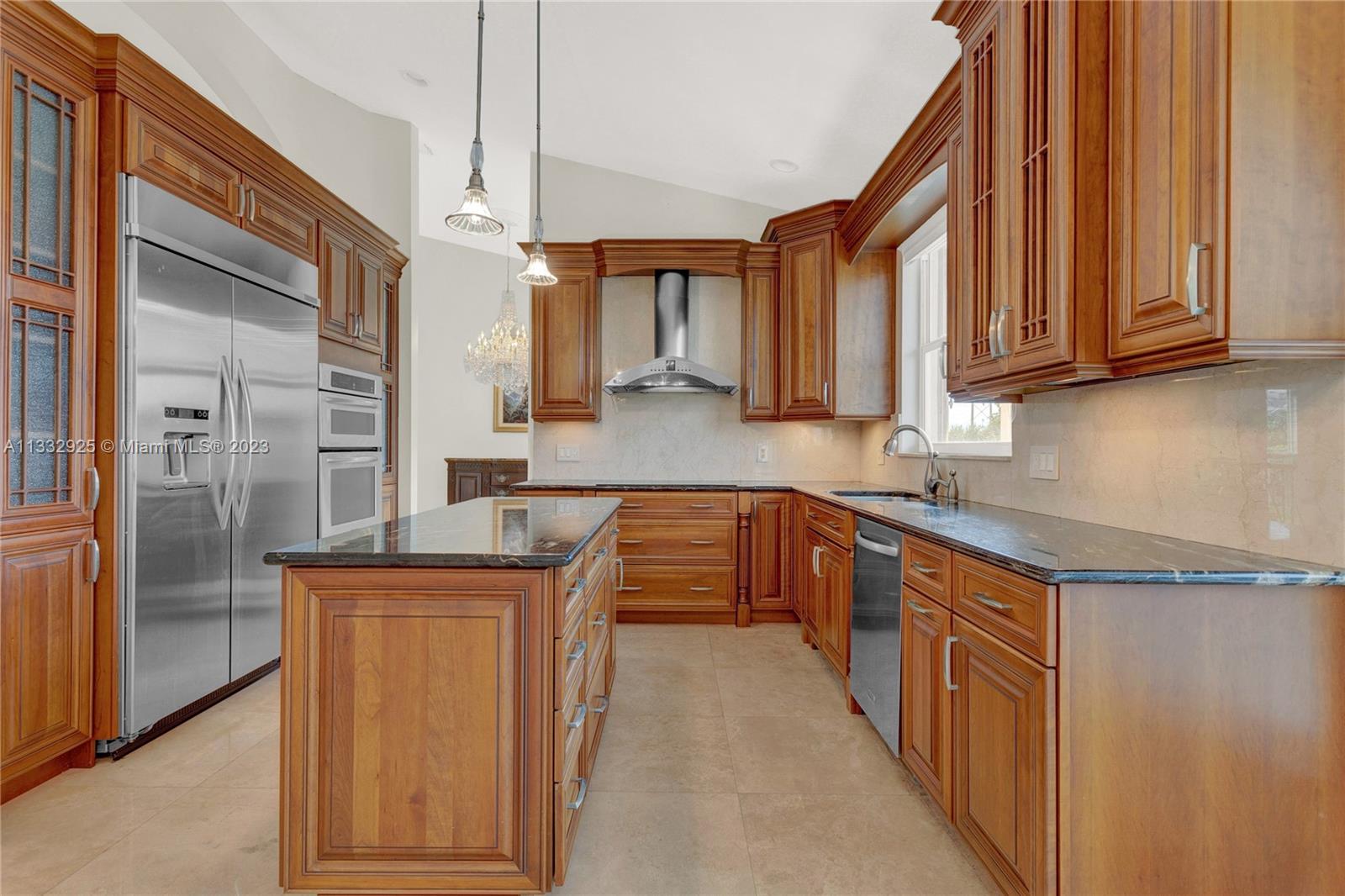 19610 Dinner Key Drive Boca Raton, FL 33498 - Photo 10 of 27 a kitchen with stainless steel appliances granite countertop a sink and a refrigerator