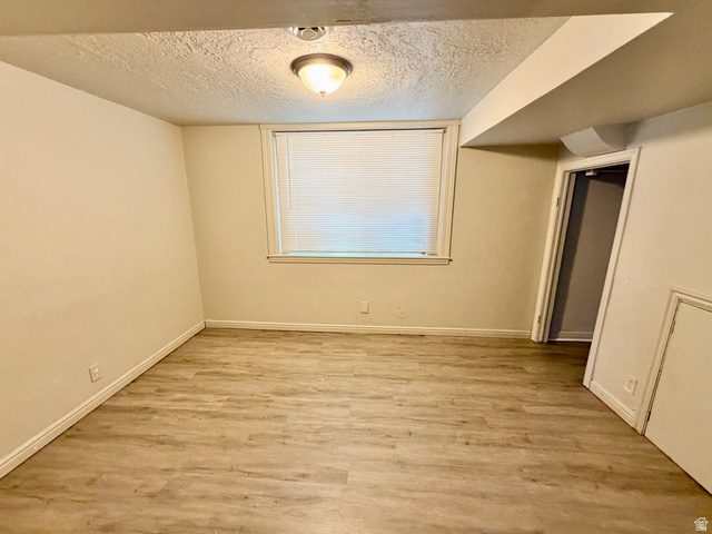 7 Foothill Boulevard Pocatello, ID 83204 - Photo 11 of 13 Room featuring wood-finish flooring, white baseboards, and a window with blinds