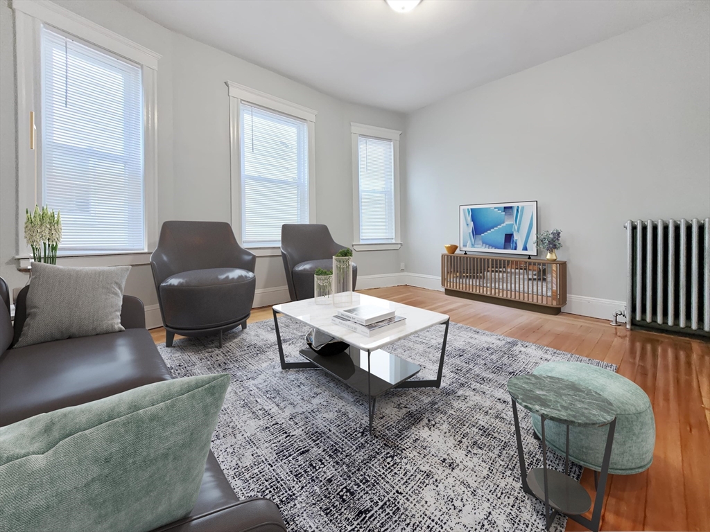 108 Callender Street, Unit 2 Boston, MA 02124 - Photo 4 of 11 a living room with furniture a rug and a window