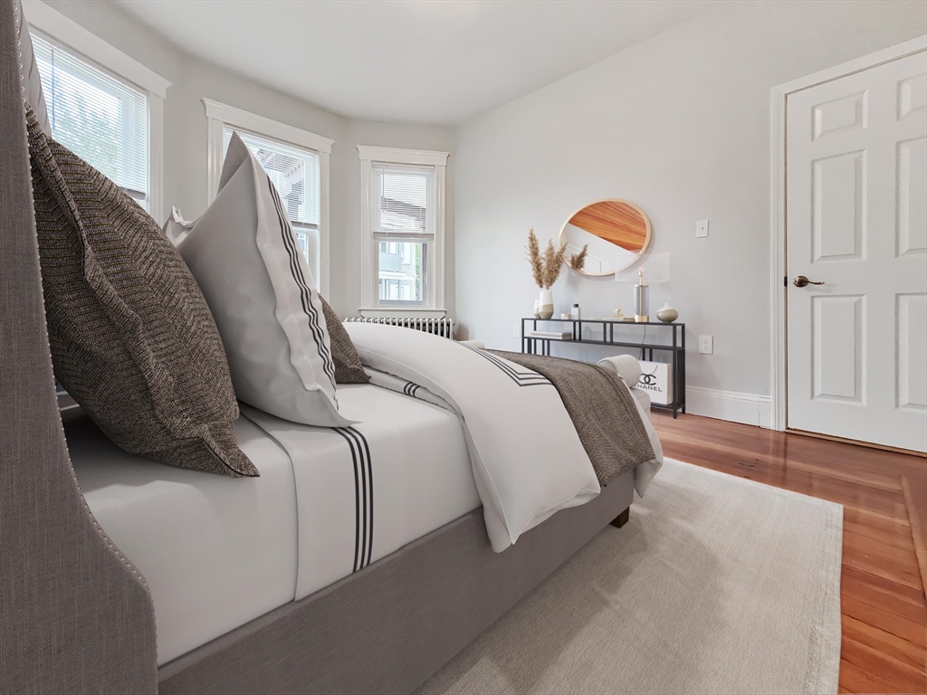 108 Callender Street, Unit 2 Boston, MA 02124 - Photo 7 of 11 a bedroom with a bed and window