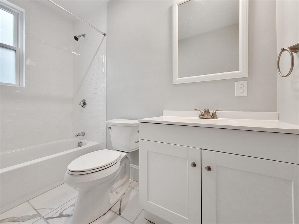 108 Callender Street, Unit 2 Boston, MA 02124 - Photo 9 of 11 a bathroom with a sink toilet vanity and tub
