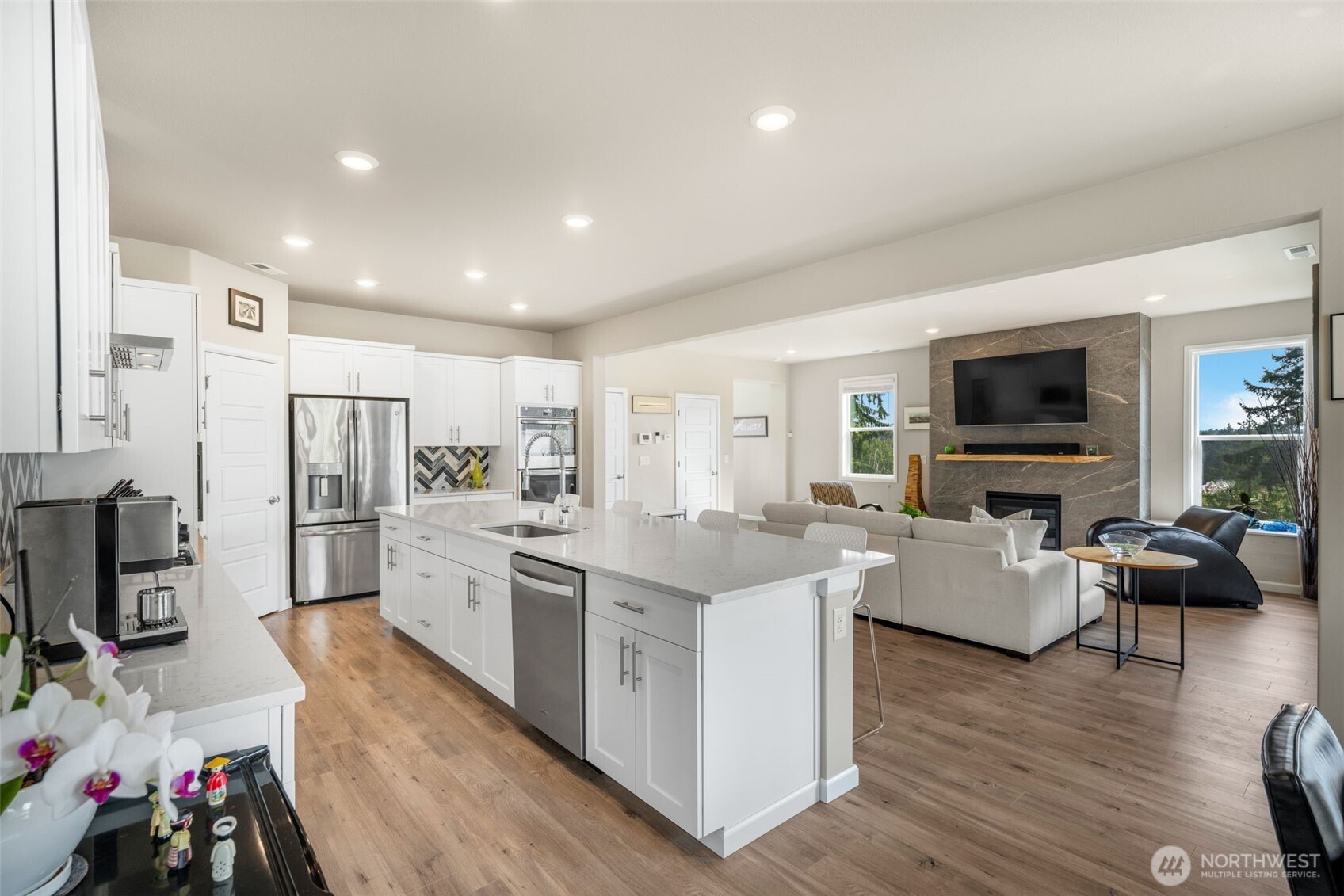 216 178th Street Southeast Bothell, WA 98012 - Photo 12 of 40 a large living room with stainless steel appliances furniture and a view of kitchen