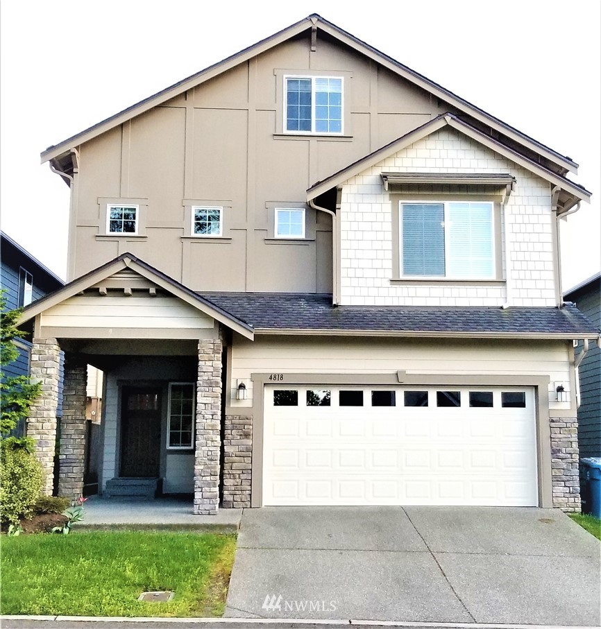 a front view of a house with a garden and plants