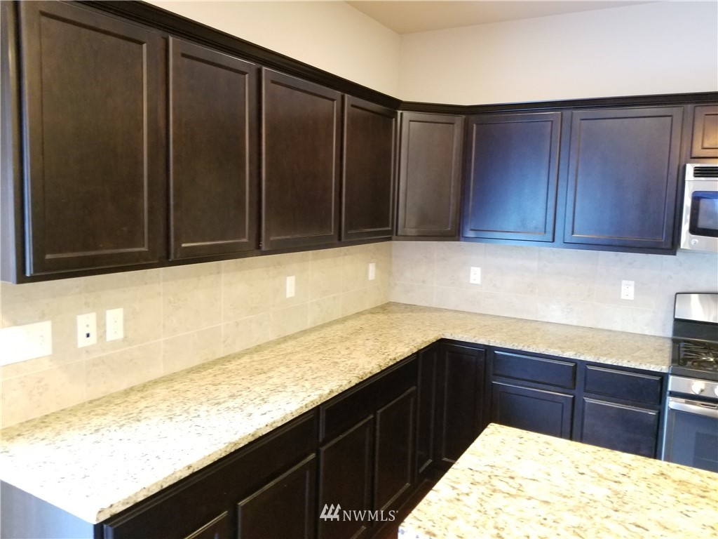 4818 155th Place Southwest, Unit 11 Edmonds, WA 98026 - Photo 11 of 30 a kitchen with a sink and cabinets