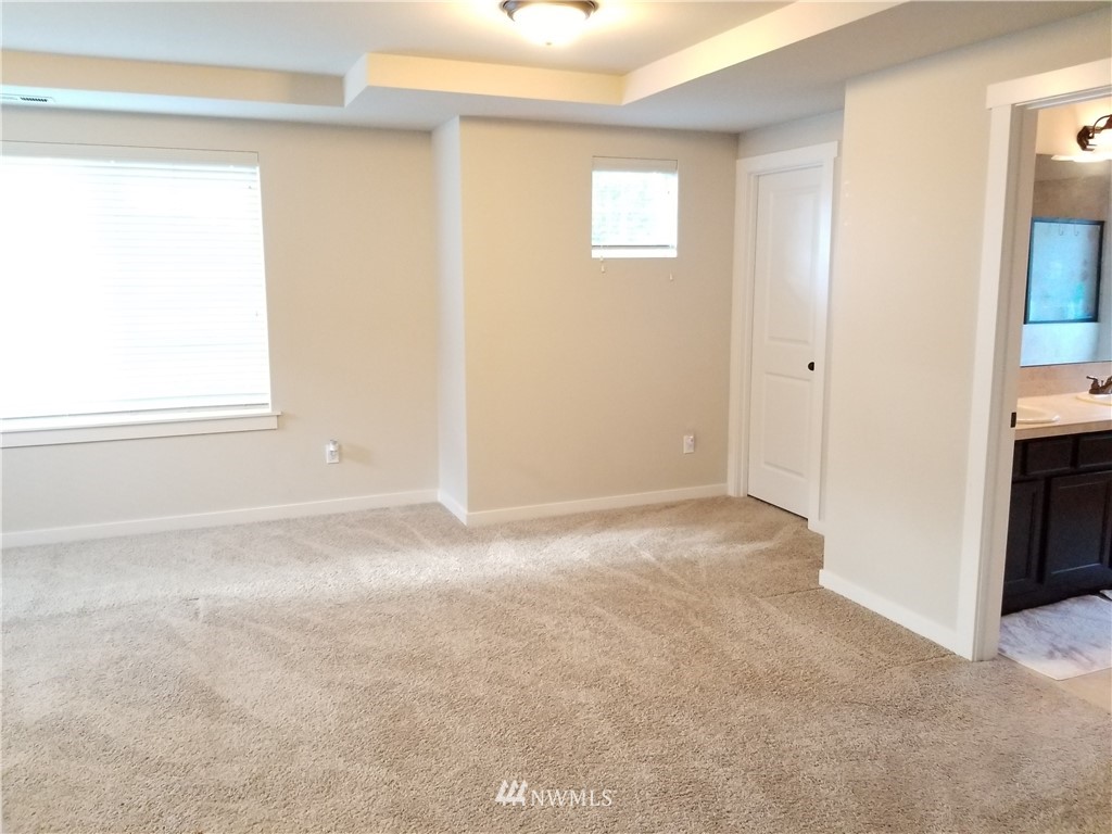 4818 155th Place Southwest, Unit 11 Edmonds, WA 98026 - Photo 12 of 30 an empty room with windows and closet