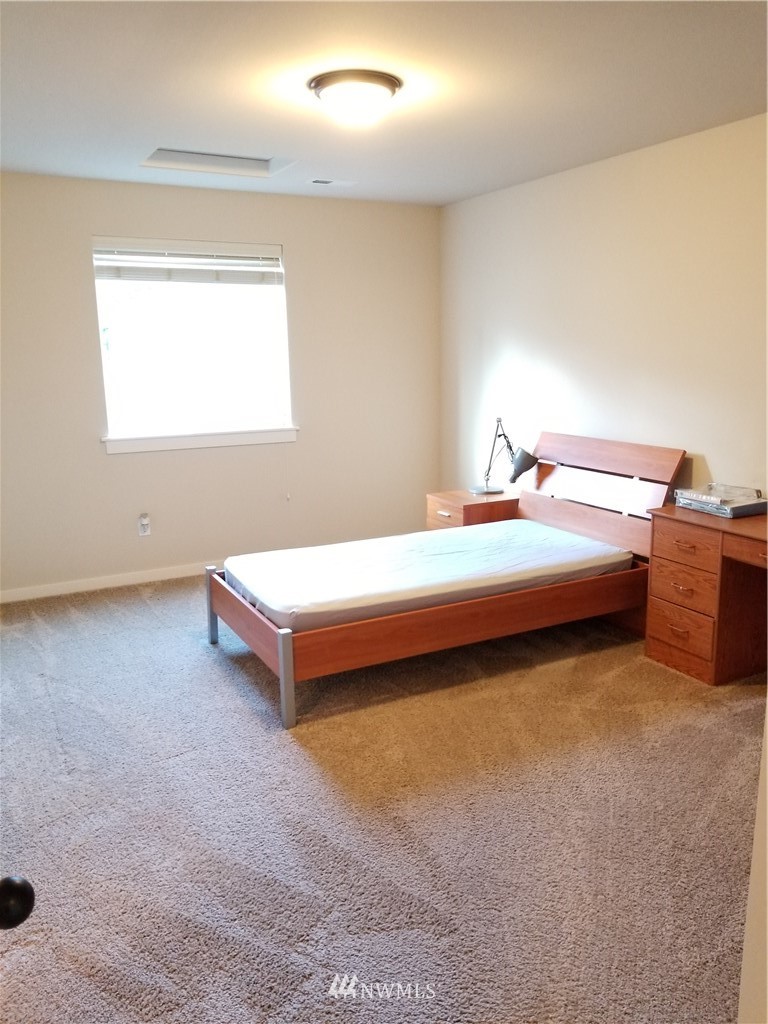 4818 155th Place Southwest, Unit 11 Edmonds, WA 98026 - Photo 15 of 30 a spacious bedroom with a bed and window