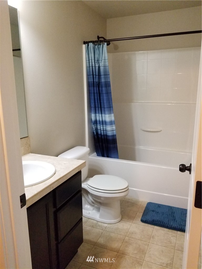 4818 155th Place Southwest, Unit 11 Edmonds, WA 98026 - Photo 17 of 30 a bathroom with a sink a toilet and shower