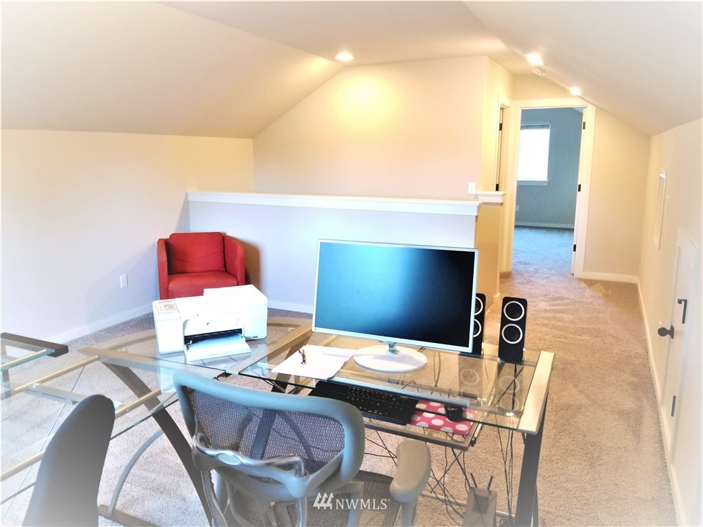 4818 155th Place Southwest, Unit 11 Edmonds, WA 98026 - Photo 20 of 30 a living room with a couch and a flat screen tv