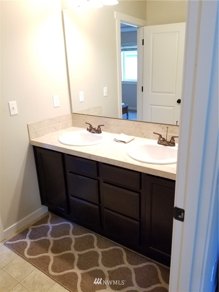 4818 155th Place Southwest, Unit 11 Edmonds, WA 98026 - Photo 23 of 30 a bathroom with a sink and a mirror