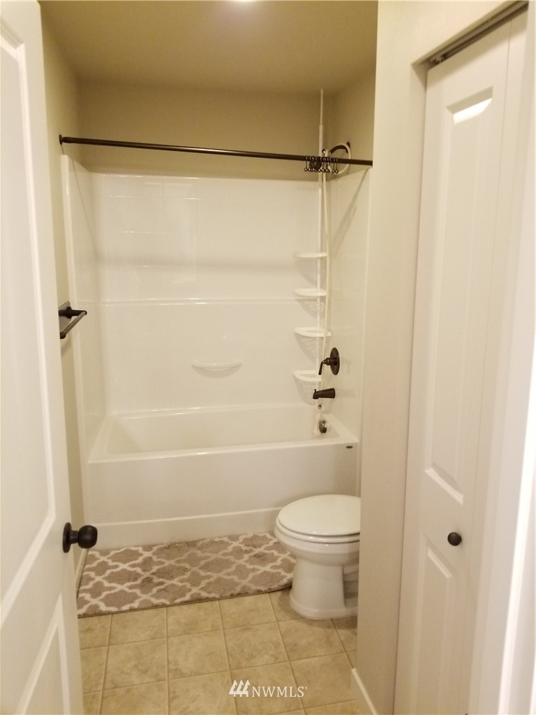 4818 155th Place Southwest, Unit 11 Edmonds, WA 98026 - Photo 24 of 30 a bathroom with a shower and a toilet