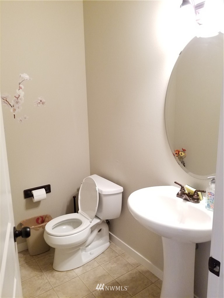 4818 155th Place Southwest, Unit 11 Edmonds, WA 98026 - Photo 28 of 30 a white toilet sitting next to a bathroom sink
