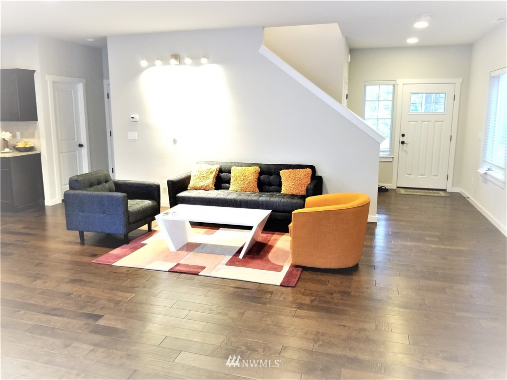 4818 155th Place Southwest, Unit 11 Edmonds, WA 98026 - Photo 4 of 30 a living room with furniture and a night stand