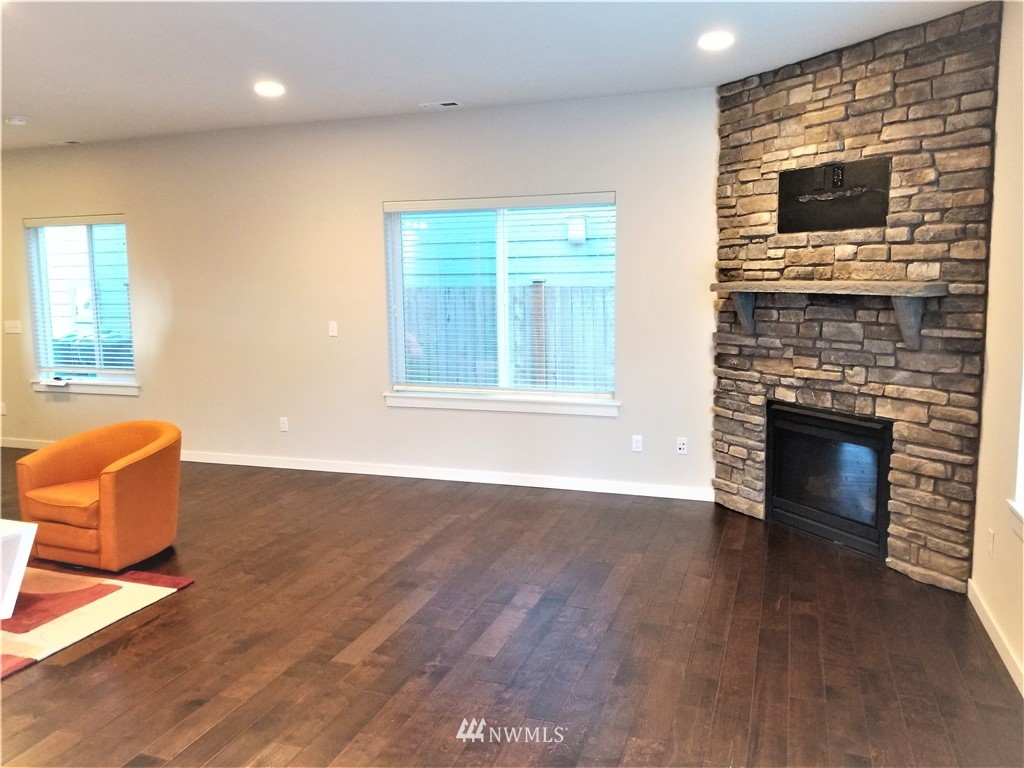 4818 155th Place Southwest, Unit 11 Edmonds, WA 98026 - Photo 7 of 30 a living room with furniture wooden floor and a fireplace