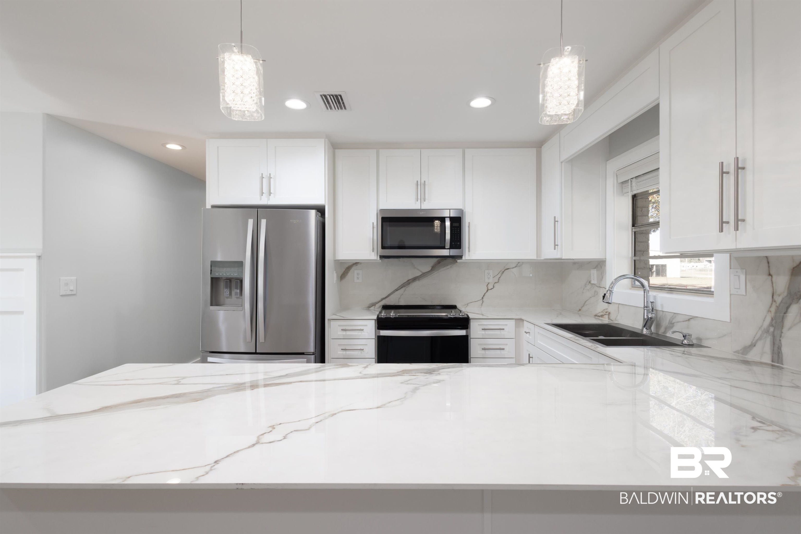 18267 Highway 98 Foley, AL 36535 - Photo 5 of 26 Kitchen featuring light stone counters, appliances with stainless steel finishes, white cabinets, decorative backsplash, and recessed lighting