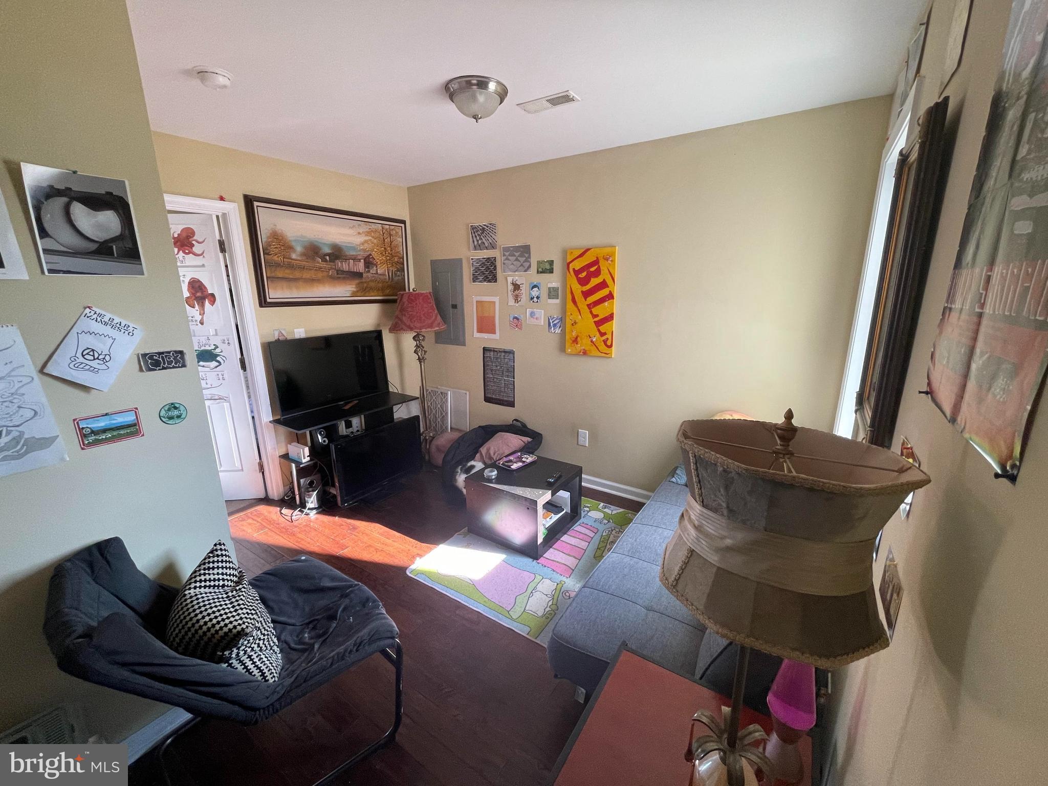 1618 Page Street, Unit A Philadelphia, PA 19121 - Photo 12 of 17 a living room with furniture and a flat screen tv