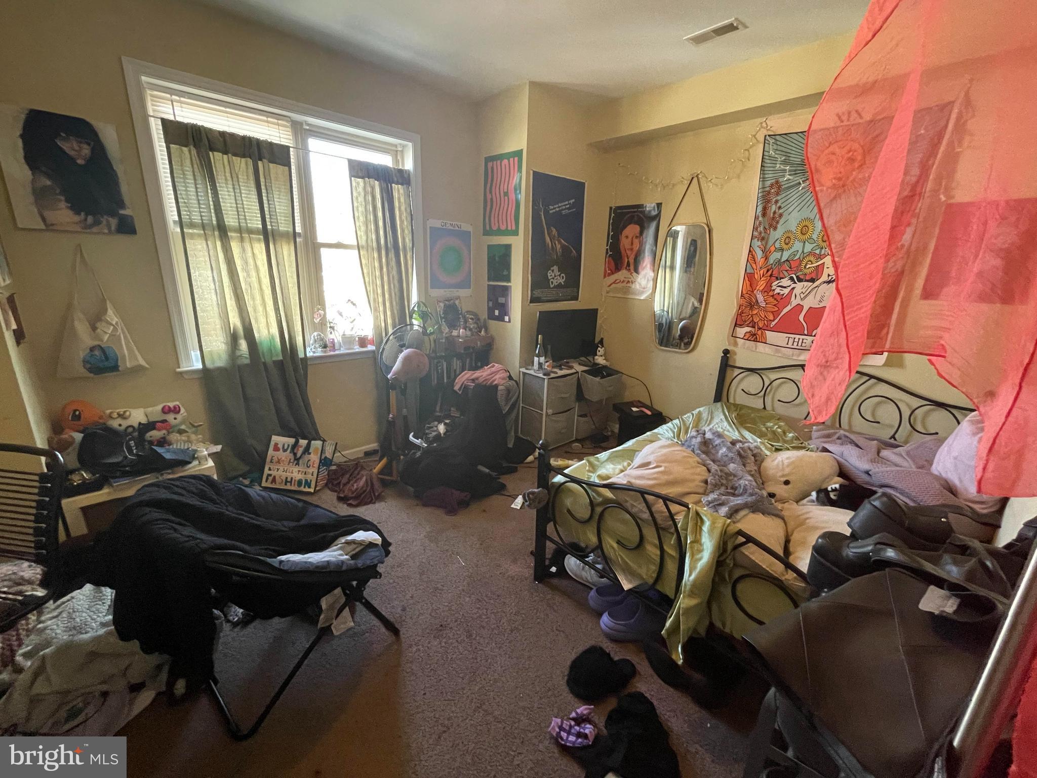 1618 Page Street, Unit A Philadelphia, PA 19121 - Photo 14 of 17 a bed room with furniture and a window