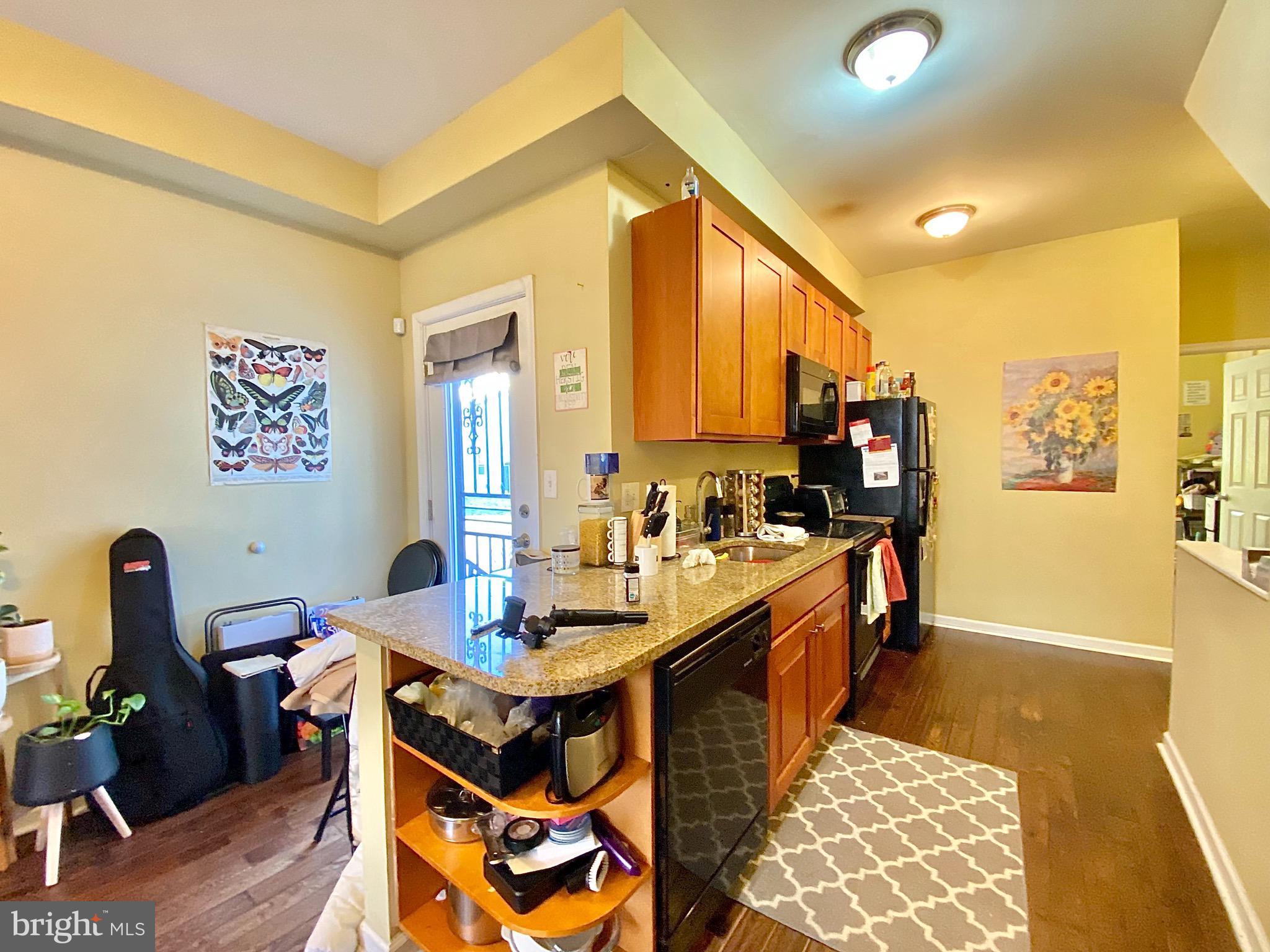 1618 Page Street, Unit A Philadelphia, PA 19121 - Photo 3 of 17 a view of a dining room with furniture and wooden floor