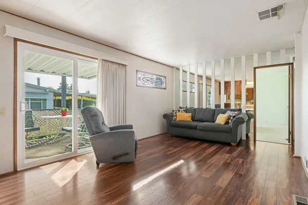 a living room with furniture and wooden floor
