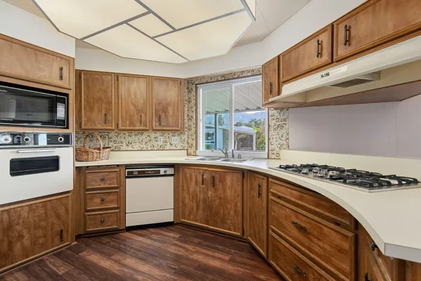 a kitchen with stainless steel appliances granite countertop a stove and a sink