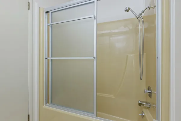 a bathroom with a glass shower door