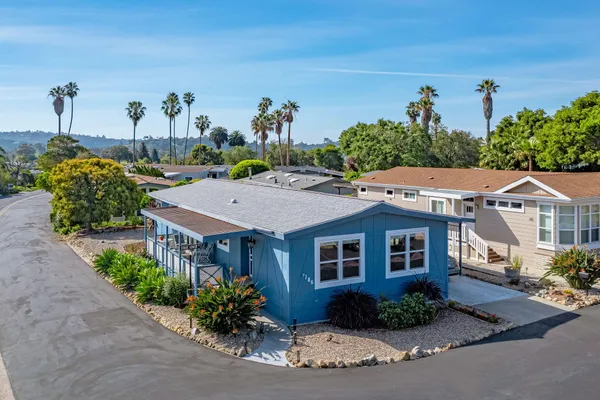 a aerial view of a house with a yard and potted plants