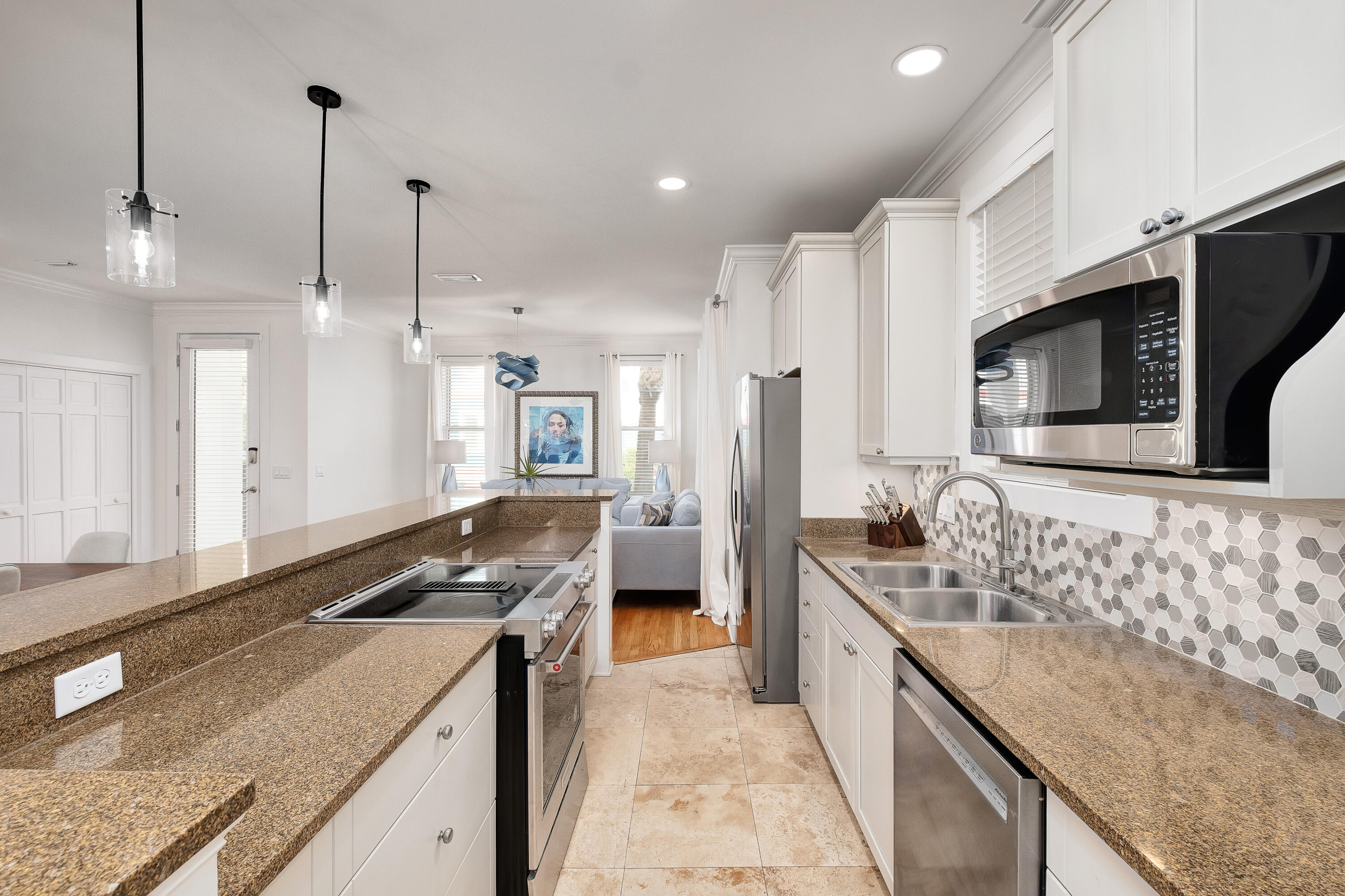 190 Seacrest Beach Boulevard West Seacrest, FL 32461 - Photo 6 of 37 a large kitchen with kitchen island granite countertop a sink and a stove top oven with wooden floor