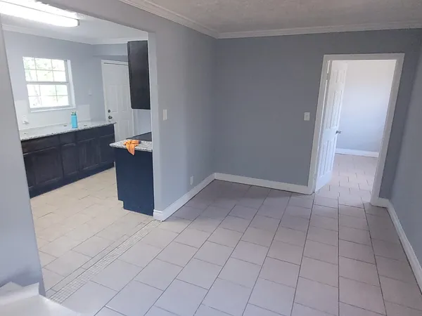 a view of kitchen with granite countertop cabinets
