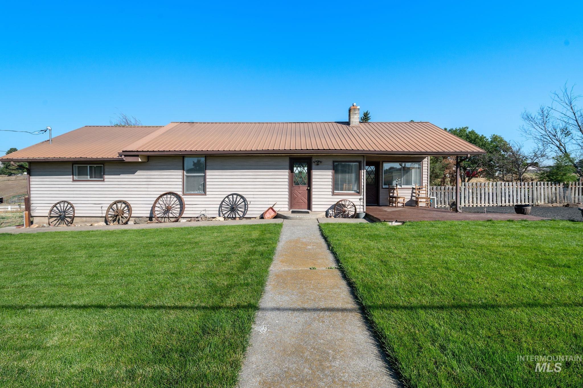 2208 4th Avenue Clarkston, WA 99403 - Photo 1 of 27 View of front of house with a metal roof and a chimney