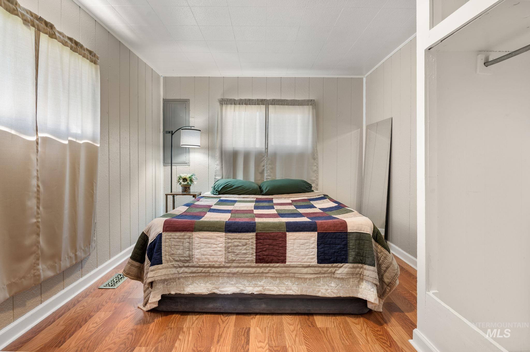 2208 4th Avenue Clarkston, WA 99403 - Photo 20 of 27 Bedroom with wood finished floors and wood walls