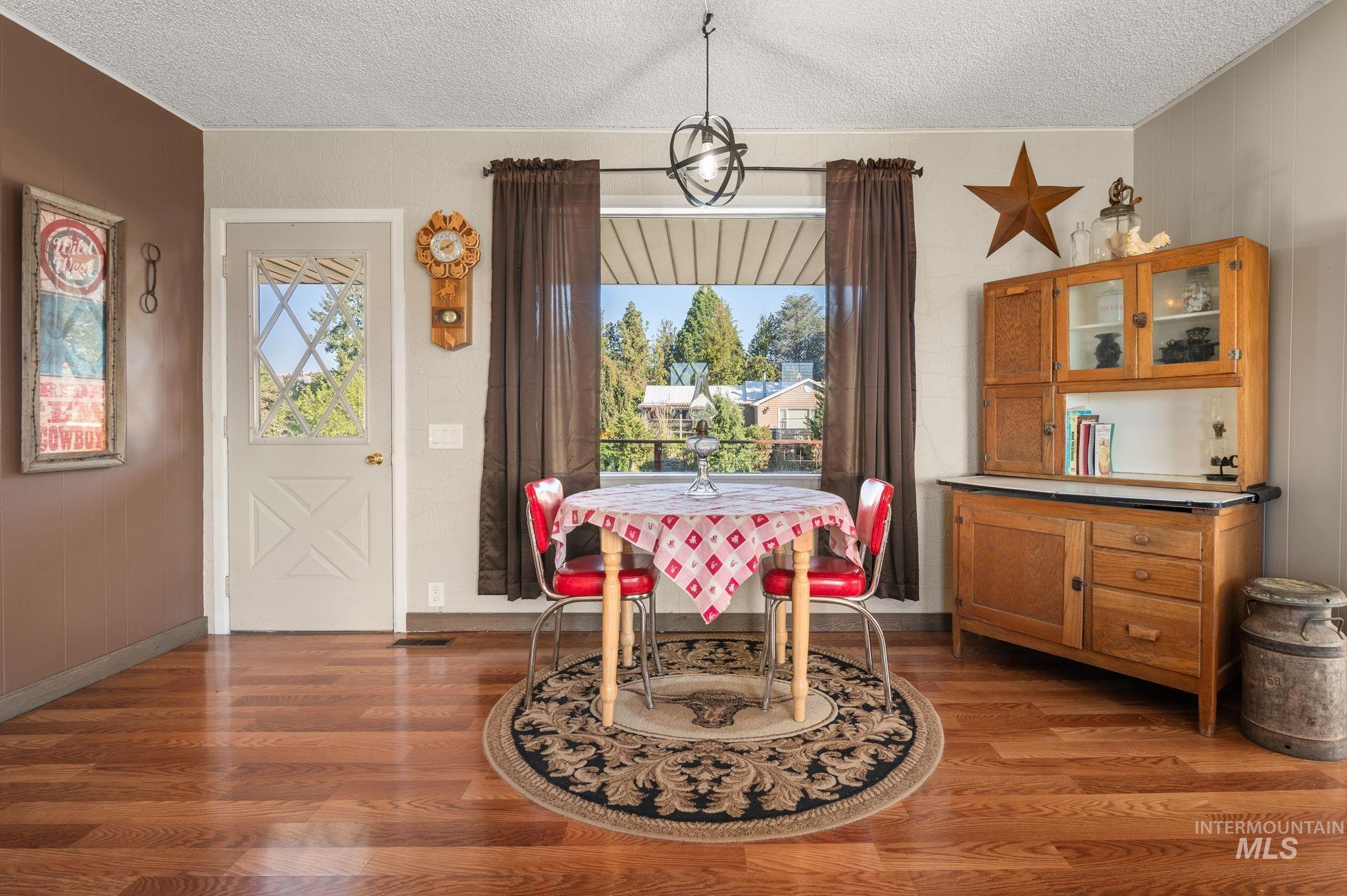 2208 4th Avenue Clarkston, WA 99403 - Photo 7 of 27 Dining area featuring dark wood-type flooring, a textured ceiling, and healthy amount of natural light