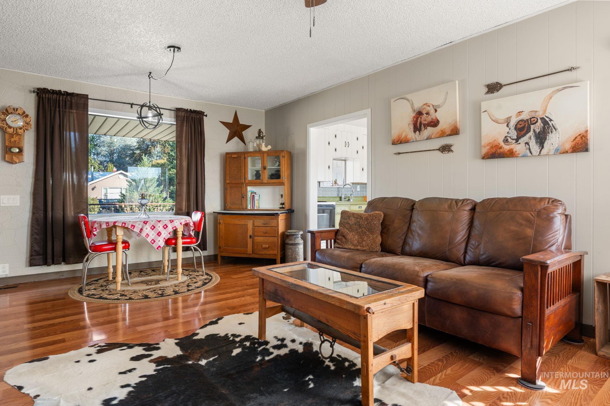 2208 4th Avenue Clarkston, WA 99403 - Photo 8 of 27 Living room featuring light wood finished floors and a textured ceiling