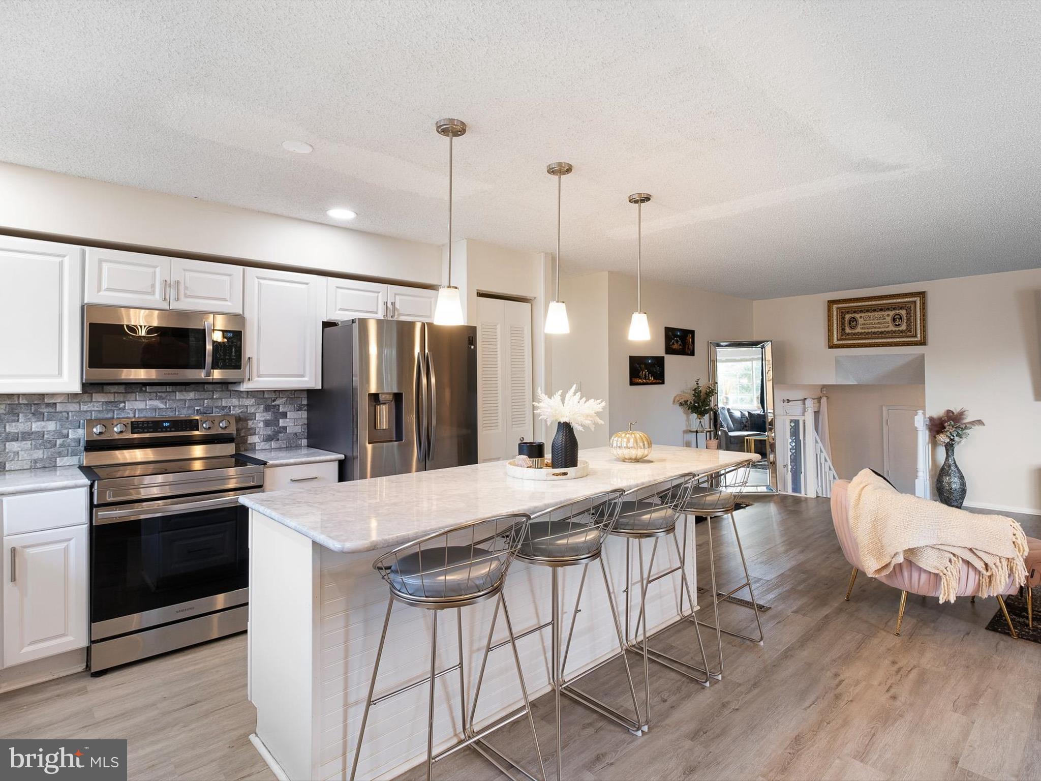 74 Valley Forge Road New Castle, DE 19720 - Photo 13 of 30 a large kitchen with stainless steel appliances kitchen island granite countertop a refrigerator a stove top oven a sink and dishwasher