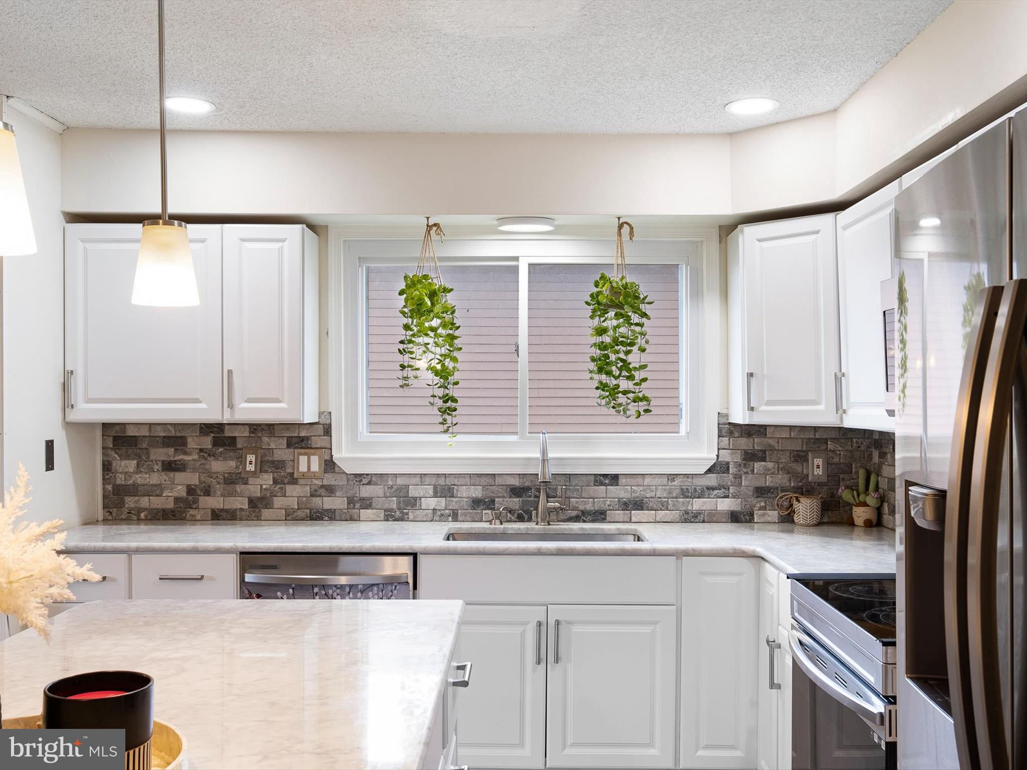74 Valley Forge Road New Castle, DE 19720 - Photo 14 of 30 a kitchen with stainless steel appliances granite countertop a sink a refrigerator and a counter space