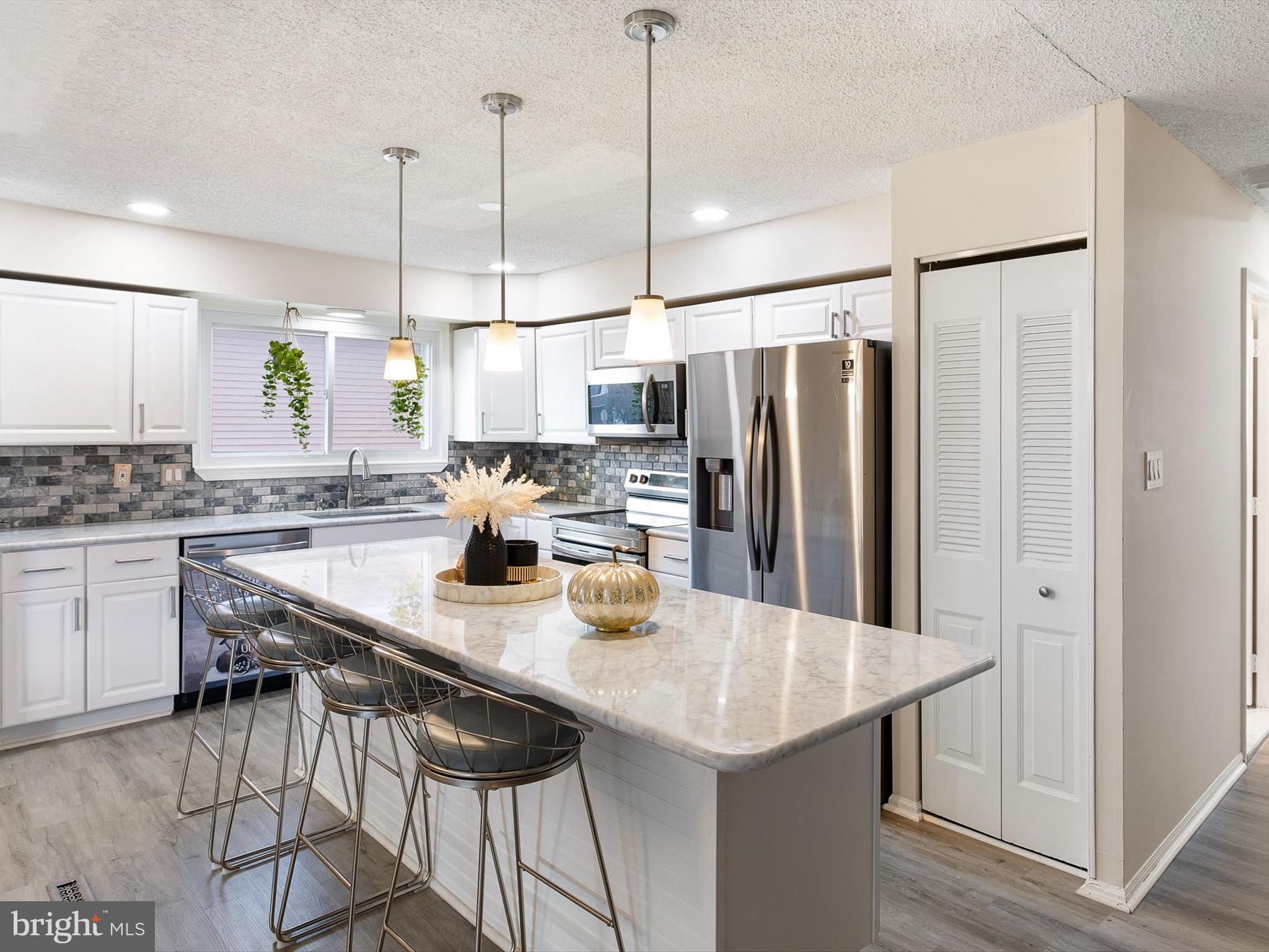 74 Valley Forge Road New Castle, DE 19720 - Photo 15 of 30 a kitchen with kitchen island a counter and chairs