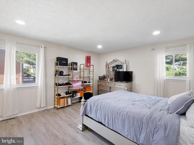 a bedroom with a bed furniture and a window