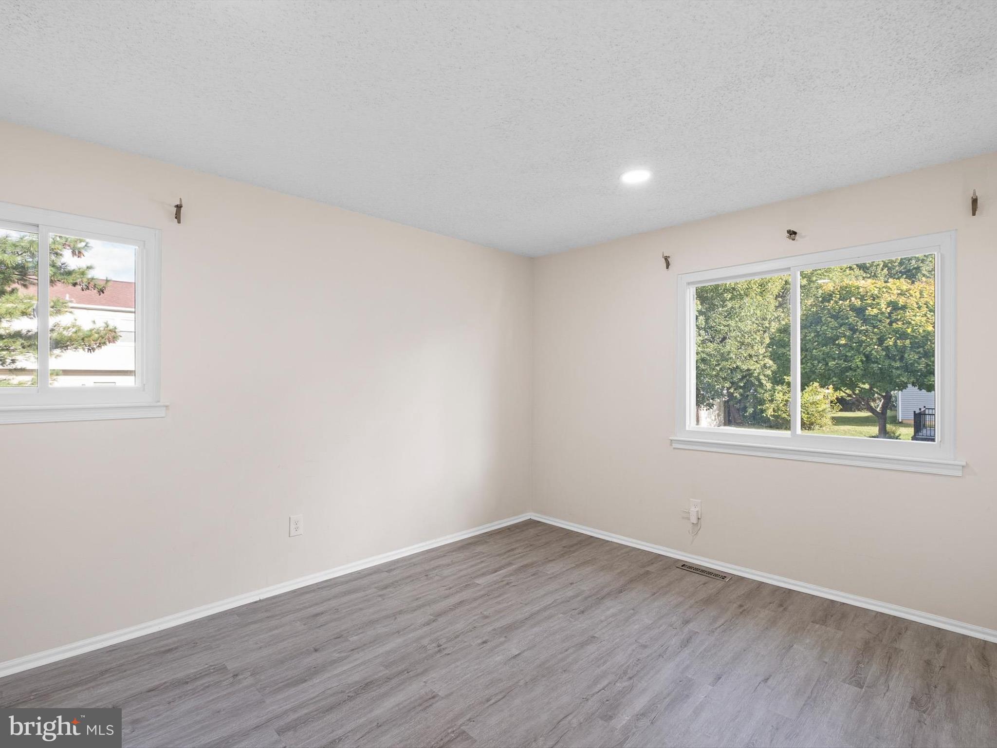 74 Valley Forge Road New Castle, DE 19720 - Photo 24 of 30 an empty room with wooden floor and windows