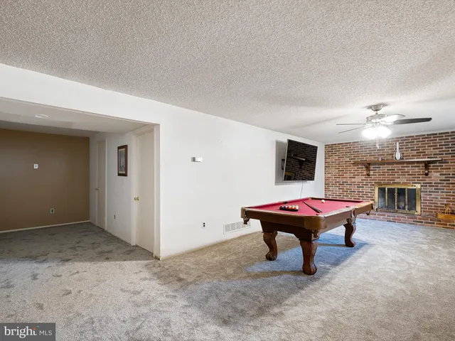 a room with a table and a fireplace