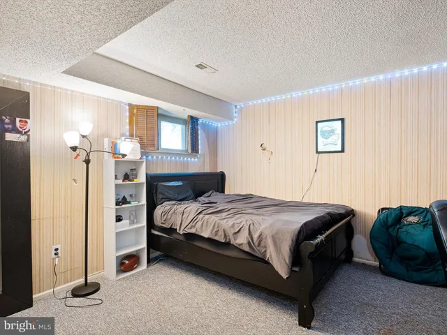 a bedroom with a bed and a night stand