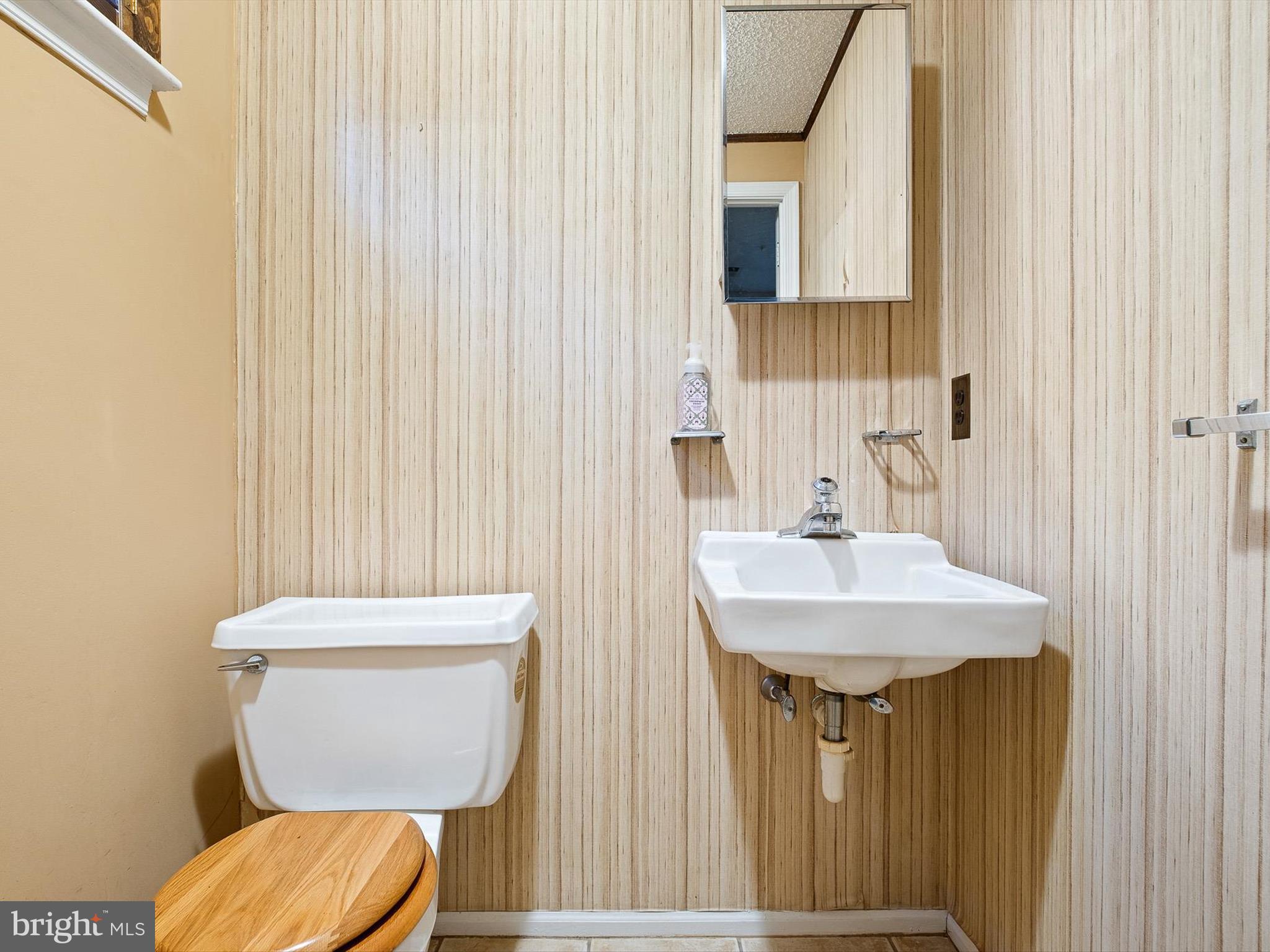 74 Valley Forge Road New Castle, DE 19720 - Photo 30 of 30 a bathroom with a sink a toilet and a mirror