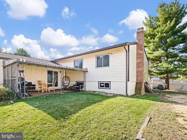 a view of a house with a yard and sitting area