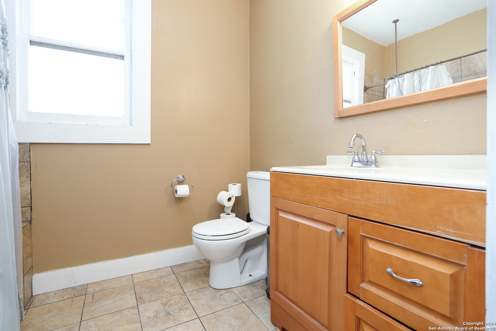 511 Devine Street San Antonio, TX 78210 - Photo 13 of 28 a bathroom with a sink toilet and mirror