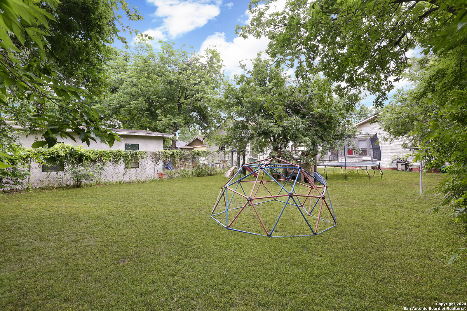 511 Devine Street San Antonio, TX 78210 - Photo 17 of 28 a house view with a play ground and a yard
